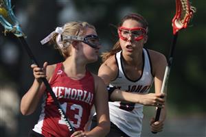 Two high school girls lacrosse players competing